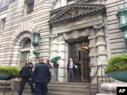 Security officers are seen outside the 9th U.S. Circuit Court of Appeals building in San Francisco, Feb. 9, 2017.