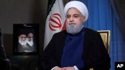 In this photo released by official website of the office of the Iranian Presidency, President Hassan Rouhani addresses the nation in a televised speech in Tehran, Aug. 6, 2018. 