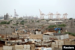 Hodeida port's cranes are pictured from a nearby shantytown in Hodeida, Yemen, June 16, 2018.