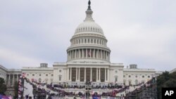 FILE - Insurrections loyal to President Donald Trump rally at the U.S. Capitol in Washington on Jan. 6, 2021.
