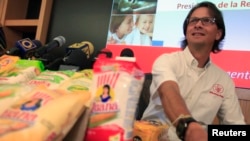 FILE - Lorenzo Mendoza, owner of Venezuela's largest private food production company Empresas Polar, attends a news conference in Caracas, May 13, 2013.