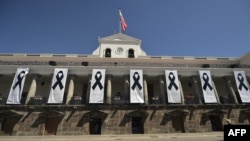 Carondelet presidential palace is shown with banners of black ribbons in honor of the victims kidnapped and recently killed by dissident FARC rebels on the Ecuador-Colombia border, taken in Quito on April 17, 2018. Two more people have been kidnapped on the Colombia-Ecuador border by the same group.