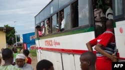 Des voyageurs montent à bord d'un bus en partance pour Bujumbura, Burundi, le 2 mai 2015. 