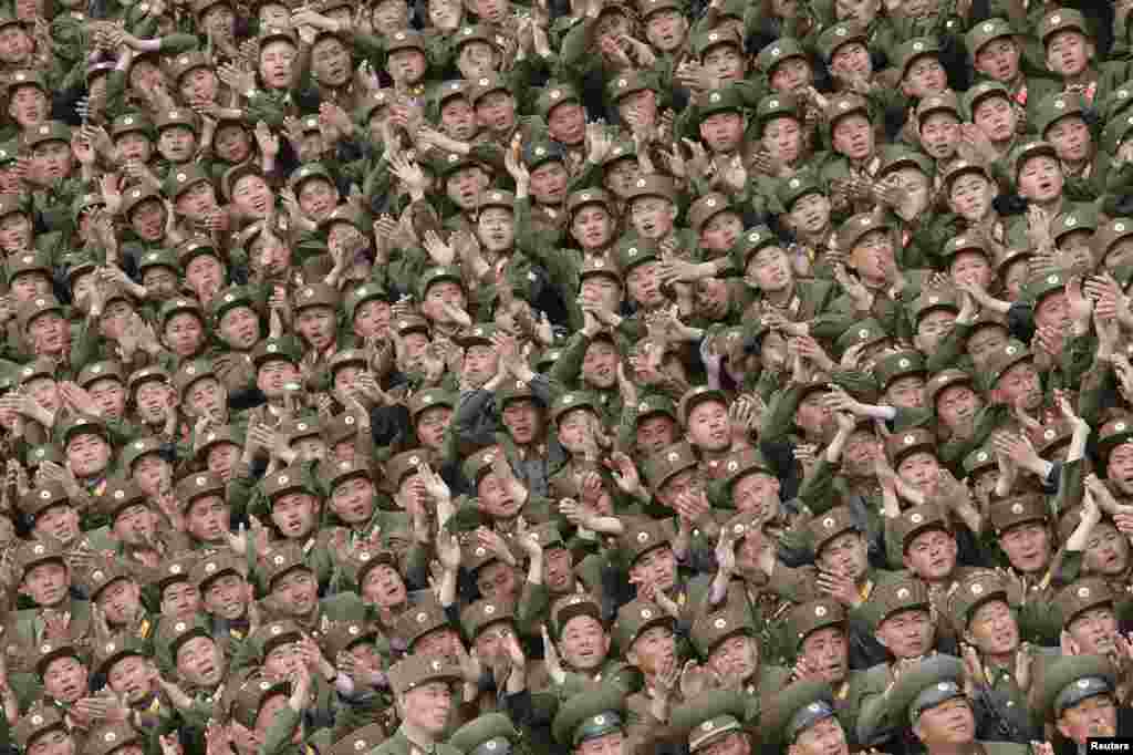 Soldiers of KPA Units 966, 462, 101, 489, who took part in building the workers' hostel of Kim Jong Suk Pyongyang Textile Mill, applaud during a photo session with North Korean leader Kim Jong Un in this undated photo released by North Korea's Korean Central News Agency (KCNA) in Pyongyang.