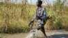 A rebel soldier patrols a flooded area near the town of Bentiu, South Sudan Saturday, Sept. 20, 2014.