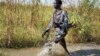 A rebel soldier patrols a flooded area near the town of Bentiu in Unity state. A report by the Geneva-based Small Arms Survey warns that both the rebels and government forces are planning new offensives in Unity state and elsewhere in South Sudan.