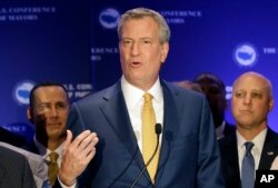 New York City Mayor Bill de Blasio talks to reporters during a news conference at the U.S. Mayors Conference, June 23, 2017, in Miami Beach, Florida.