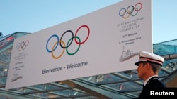 A Monaco policeman stands in front of the Grimaldi Forum during the opening of the 127th International Olympic Committee (IOC) session in Monaco, Dec. 8, 2014. 