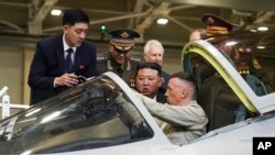 FILE - North Korean leader Kim Jong Un, center, looks at a Russian military jet cockpit on Sept. 15, 2023. South Korea’s president Yoon Suk Yeol said the international community “will unite more tightly” to cope with deepening military cooperation between Russia and North Korea. 