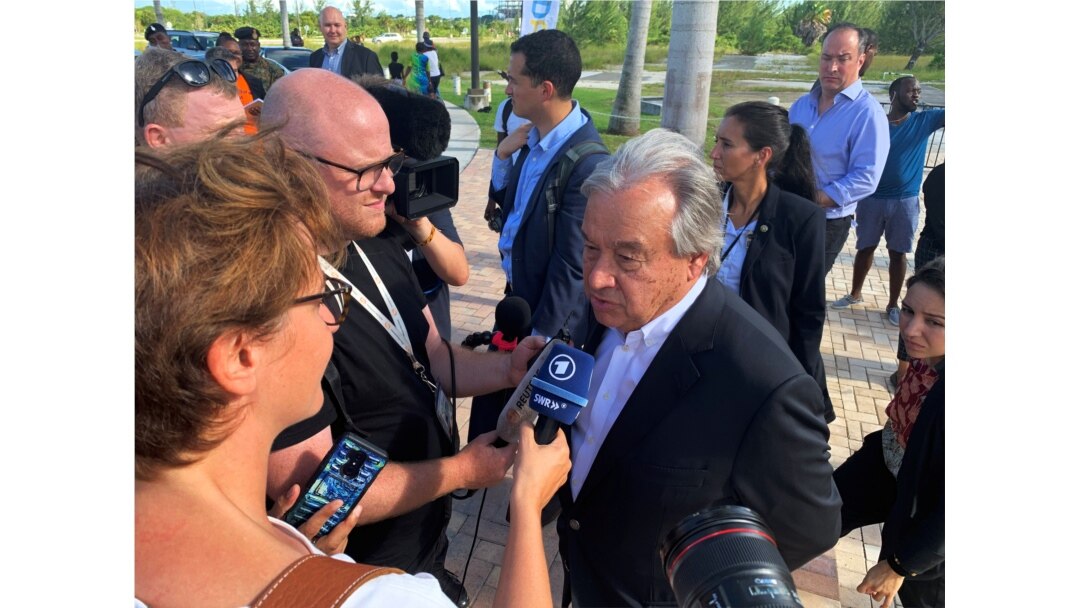 FILE - U.N. Secretary-General Antonio Guterres talks to the media outside an evacuation center in Nassau, Bahamas, Sept. 13, 2019.