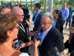 FILE - U.N. Secretary-General Antonio Guterres talks to the media outside an evacuation center in Nassau, Bahamas, Sept. 13, 2019.