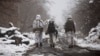 FILE - Ukrainian soldiers walks near the line of separation from Russia-backed rebels near Katerynivka, Donetsk region, Ukraine, Dec 7, 2021.