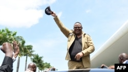 FILE - Tanzanian opposition stalwart Tundu Lissu reacts to supporters upon his return after about five years in exile, at the Julius Nyerere International Airport in Dar es Salaam on January 25, 2023.