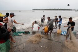 Fishermen gather their nets by the sea shore to store them before cyclone Nisarga makes its landfall, in Mumbai, India, June 3, 2020.
