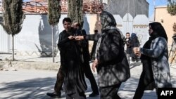 Relatives of the victims arrive at the site where gunmen shot and killed two Afghan women judges working for the Supreme Court in Kabul on Jan. 17, 2021.