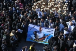 FILE - Iranian mourners gather during the final stage of funeral processions for slain top general Qassem Soleimani, in his hometown Kerman, Jan. 7, 2020.