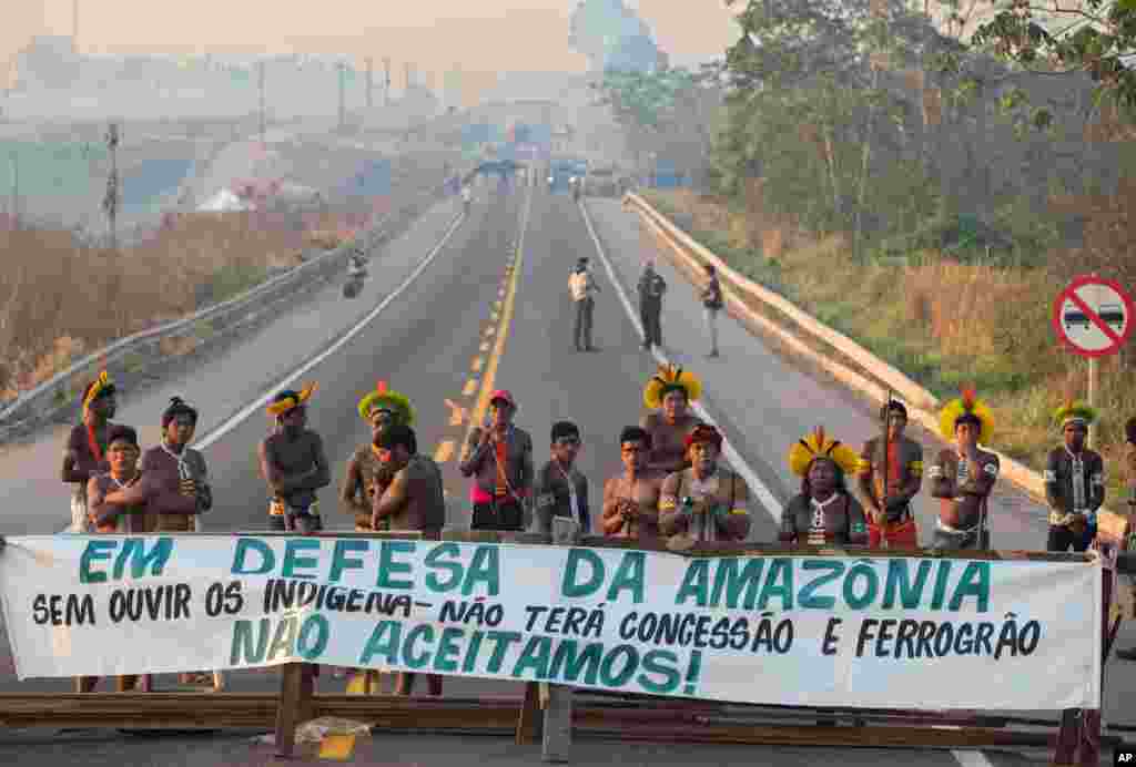 Kayapo Indigenous protesters block highway BR-163 with a banner that reads in Portuguese "Defending the Amazon. Without listening to Indigenous people, there will be no concession and nor grain railway," near Novo Progresso, Para state, Brazil.