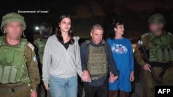 TOPSHOT - This handout picture courtesy of the government of Israel taken on October 20, 2023 shows Natalie Shoshana Raanan (2nd L) and Judith Tai Raanan (2nd R) after being held hostage and later released by Hamas at an undiclosed location.