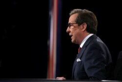 FILE - Fox News' Chris Wallace moderates the third and final 2016 presidential campaign debate between Republican presidential nominee Donald Trump and Democratic presidential nominee Hillary Clinton at UNLV in Las Vegas, Oct. 19, 2016.