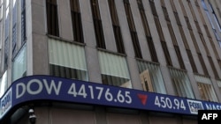 A Fox News ticker tape on the side of the News Corp. Building displays statistics about the stock market, in New York City, March 12, 2025.