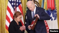 Loretta Orig accepts the Medal of Honor posthumously on behalf of her brother, Private Bruno R. Orig, from President Joe Biden during a ceremony at the White House in Washington, Jan. 3, 2025. 