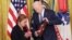 Loretta Orig accepts the Medal of Honor posthumously on behalf of her brother, Private Bruno R. Orig, from President Joe Biden during a ceremony at the White House in Washington, Jan. 3, 2025. 