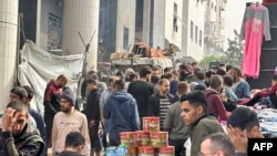 Displaced Palestinians gather in the yard of Gaza's Al-Shifa hospital on December 10, 2023, as battles continue between Israel and the militant group Hamas in the Palestinian territory.