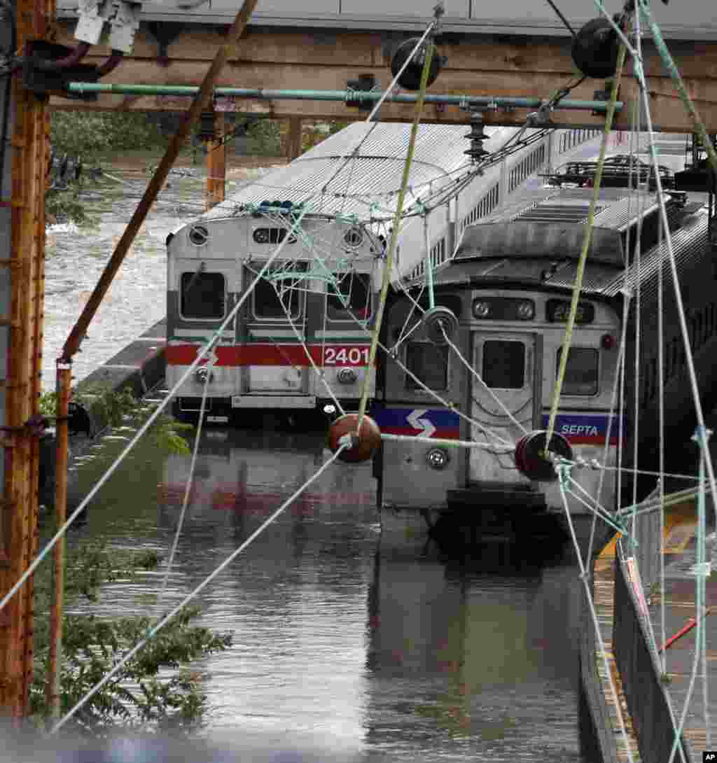 Two Southeastern Pennsylvania Transportation Authority trains sit in water on flooded tracks at Trenton train station Sunday, Aug. 28, 2011, in Trenton, New Jersey, as rains from Hurricane Irene are causing inland flooding of rivers and streams. (AP Photo