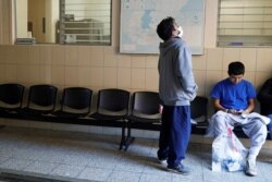 FILE - Migrants from Honduras and El Salvador wait after being sent back to Guatemala from the United States, at Casa del Migrante shelter in Guatemala City, Guatemala, Dec. 3, 2019.