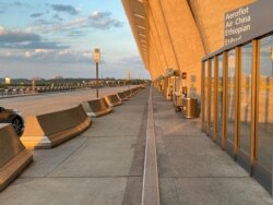 The normally bustling Dulles Airport was forlorn. “There were just three other international flights departing the airport on the night I flew out.” (Jamie Dettmer/VOA)