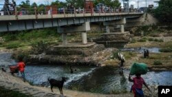 ২০২১ সালের ১৯ নভেম্বর, ডোমিনিকান রিপাবলিক এবং হাইতি সীমান্তে ম্যাসাকার নদীতে লোকজন গোসল করছে। ফাইল ছবি।