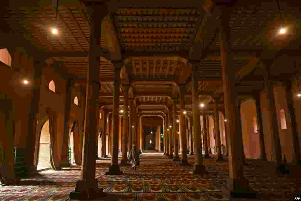 A Muslim devotee walks inside the Jamia Masjid mosque during the holy month of Ramadan, in Srinagar, India.