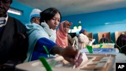 Kenyans cast their vote in a general election at the Mutomo primary school near Gatundu, north of Nairobi, early Monday morning