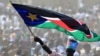 A man waves South Sudan's national flag as he attends the Independence Day celebrations in the capital Juba, July 9, 2011