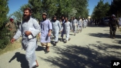 FILE - Prisoners are released from Bagram Prison in Parwan province, Afghanistan, May 26, 2020. 