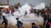Protesting farmers run away from tear gas shells used by the police near Shambhu border that divides northern Punjab and Haryana states, some 200 kilometers (120 miles) from New Delhi, India, Feb.21, 2024. 
