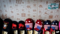 FILE - Chinese made children shoes carying a Chinese map and U.S. flags are on display for a sale at a shop in Beijing, July 13, 2018. 