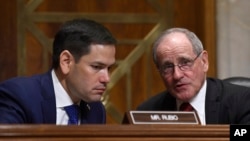 FILE - Republican Senator Jim Risch (R) talks with fellow Republican Senator Marco Rubio during a hearing on Capitol Hill in Washington, April 10, 2019.