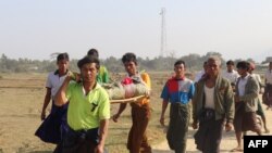 Residents carrying a body of an ethnic Rakhine woman for burial in Rathedaung township after fresh fighting in Rakhine state between the Myanmar military and the Arakan Army, an ethnic Rakhine force, Feb. 21, 2019.