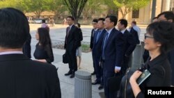 Miembros de la delegación comercial de China, encabezada por el vice ministro Wang Shouwen aguardan para ingresar a la sede el Departamento del Tesoro en Washington, D.C., el jueves, 23 de agosto de 2018.