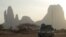 FILE - A French armored vehicle drives by Mount Hombori during France's Operation Barkhane in Mali's Gourma region, March 27, 2019.