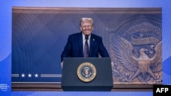 US President Donald Trump is seen on a large screen during his address by video conference at the World Economic Forum (WEF) annual meeting in Davos on January 23, 2025.