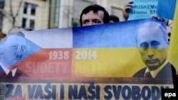 Czech Republic – Protestor holds anti Putin banner during a rally in protest against the Russian military actions in Crimea, in Prague, Czech Republic, 08 March 2014