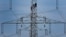 FILE - In this Monday, April 11, 2011 file photo, workers of the German energy company RWE prepare power supply on a high power pylon in Moers, Germany. The world's facing an energy crunch. Europe is feeling it worst as natural gas prices skyrocket to fiv