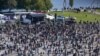 A general view taken from a wheel shows people gathering during a protest against the government's restrictions, amid the coronavirus disease (COVID-19) outbreak, in Konstanz, Germany Oct. 4, 2020. 