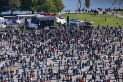 A general view taken from a wheel shows people gathering during a protest against the government's restrictions, amid the coronavirus disease (COVID-19) outbreak, in Konstanz, Germany, Oct. 4, 2020.