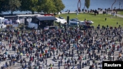 A general view taken from a wheel shows people gathering during a protest against the government's restrictions, amid the coronavirus disease (COVID-19) outbreak, in Konstanz, Germany Oct. 4, 2020. 