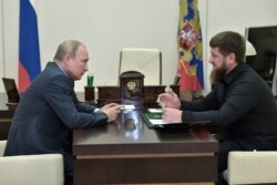 FILE - Russia's President Vladimir Putin meets with head of the Chechen Republic Ramzan Kadyrov at his residence near Moscow, Aug. 31, 2019.