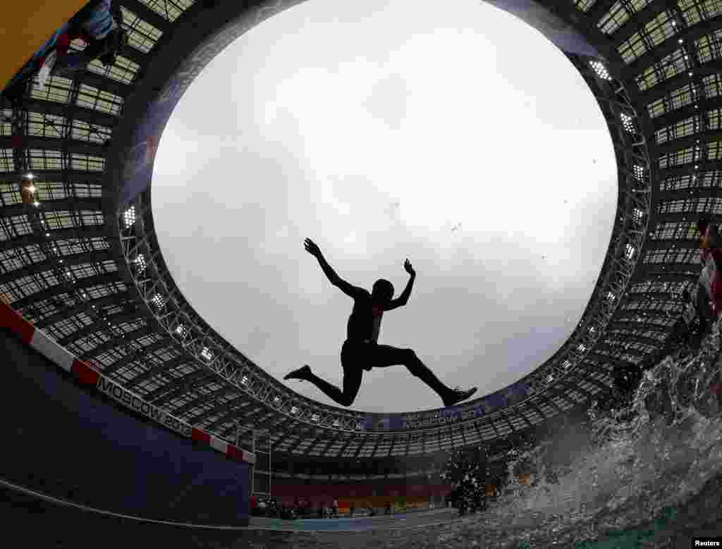 Paul Kipsiele Koech of Kenya jumps a water obstacle in the men&#39;s 3000 metres steeplechase heat during the IAAF World Athletics Championships at the Luzhniki Stadium in Moscow, Russia. 