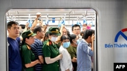 People board a train of the Line 1 of the HCMC Metro at a metro station in Ho Chi Minh City on Dec. 22, 2024.